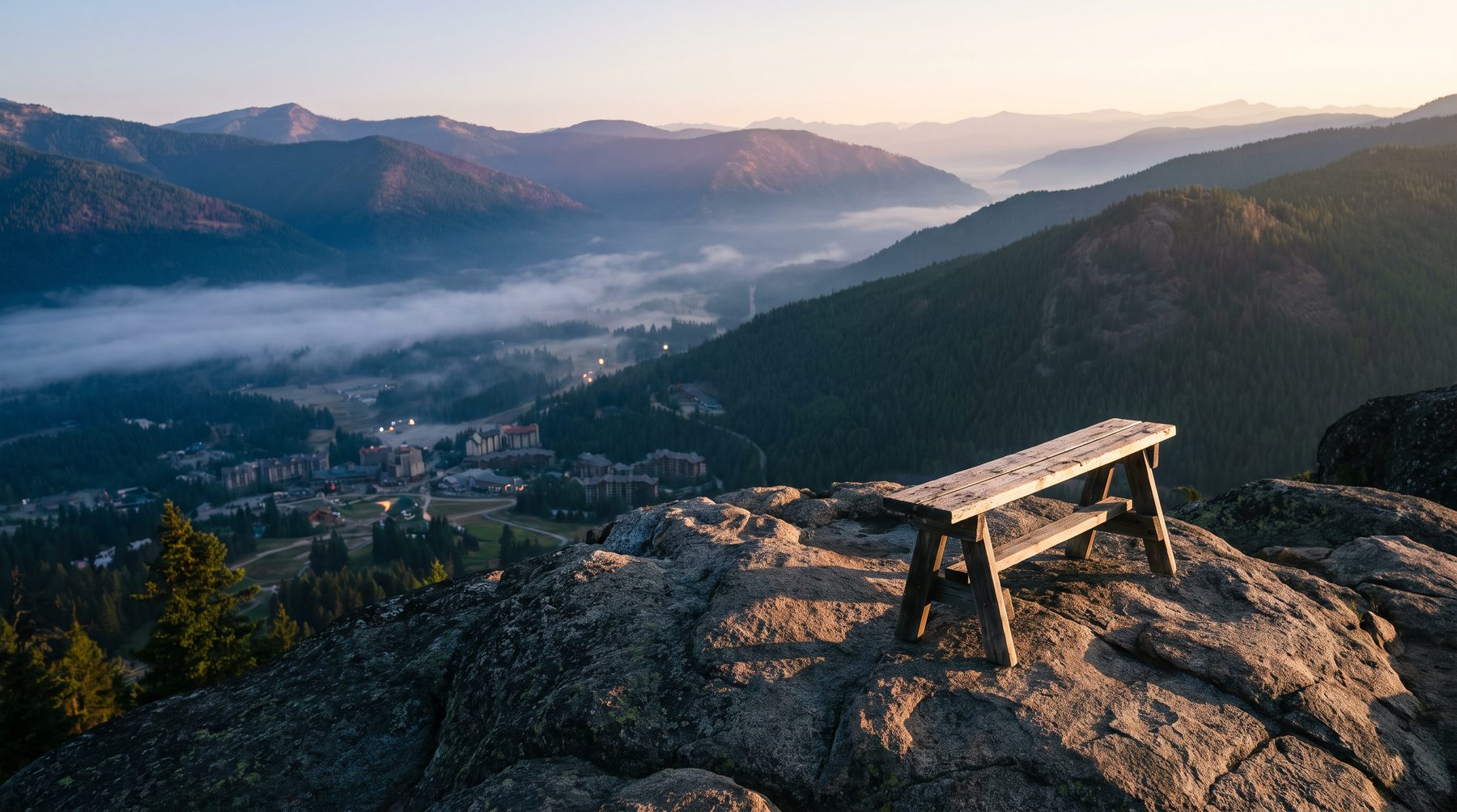 Architect reviewing site plans for a mountain resort development with a valley view beyond